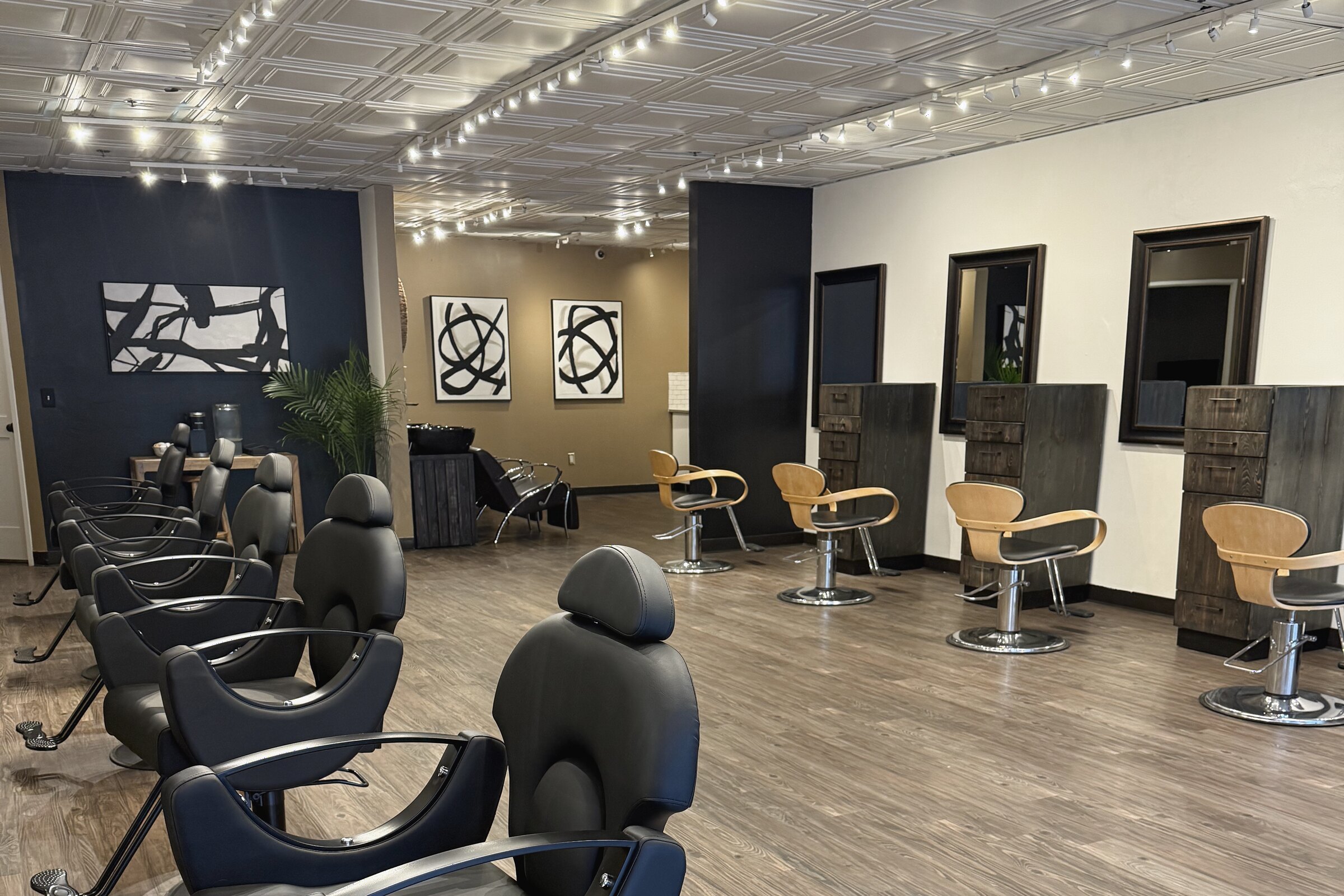 Modern luxury salon interior with styling chairs, mirrors, art, and refined finishes